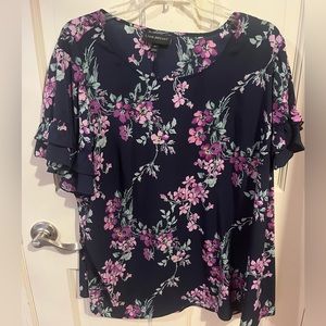 Navy and pink/purple floral short sleeve top with ruffle sleeves.
